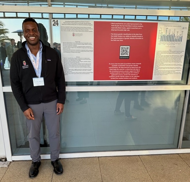 man standing beside research poster