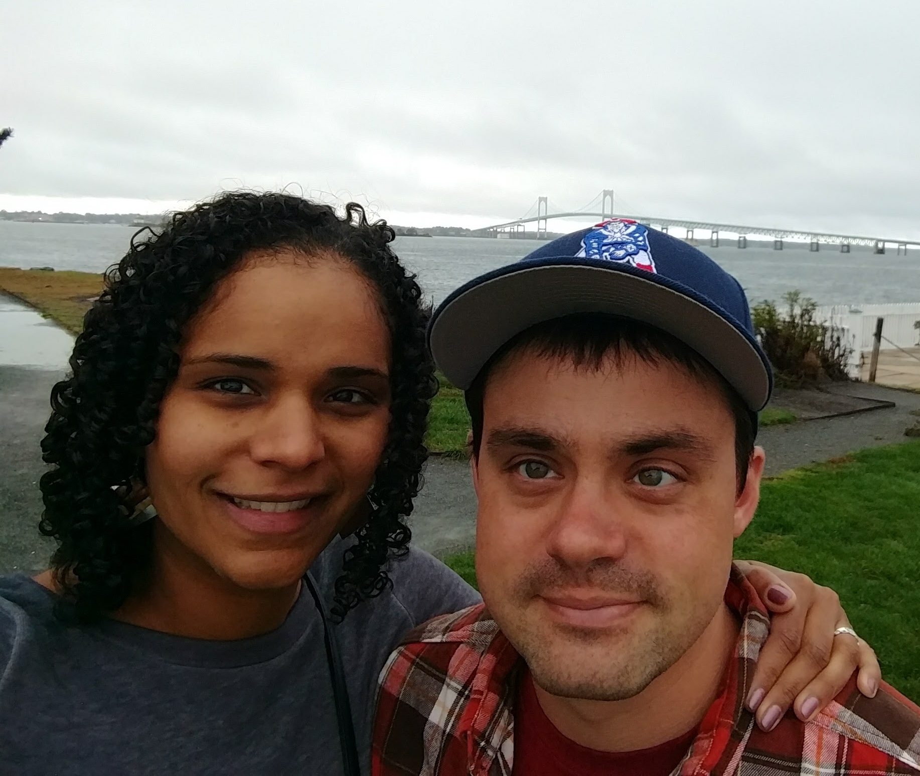 Selfie of couple with bridge in distance