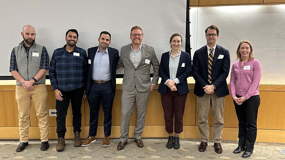 several people posing for a photo in a classroom