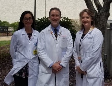 three people in white coats