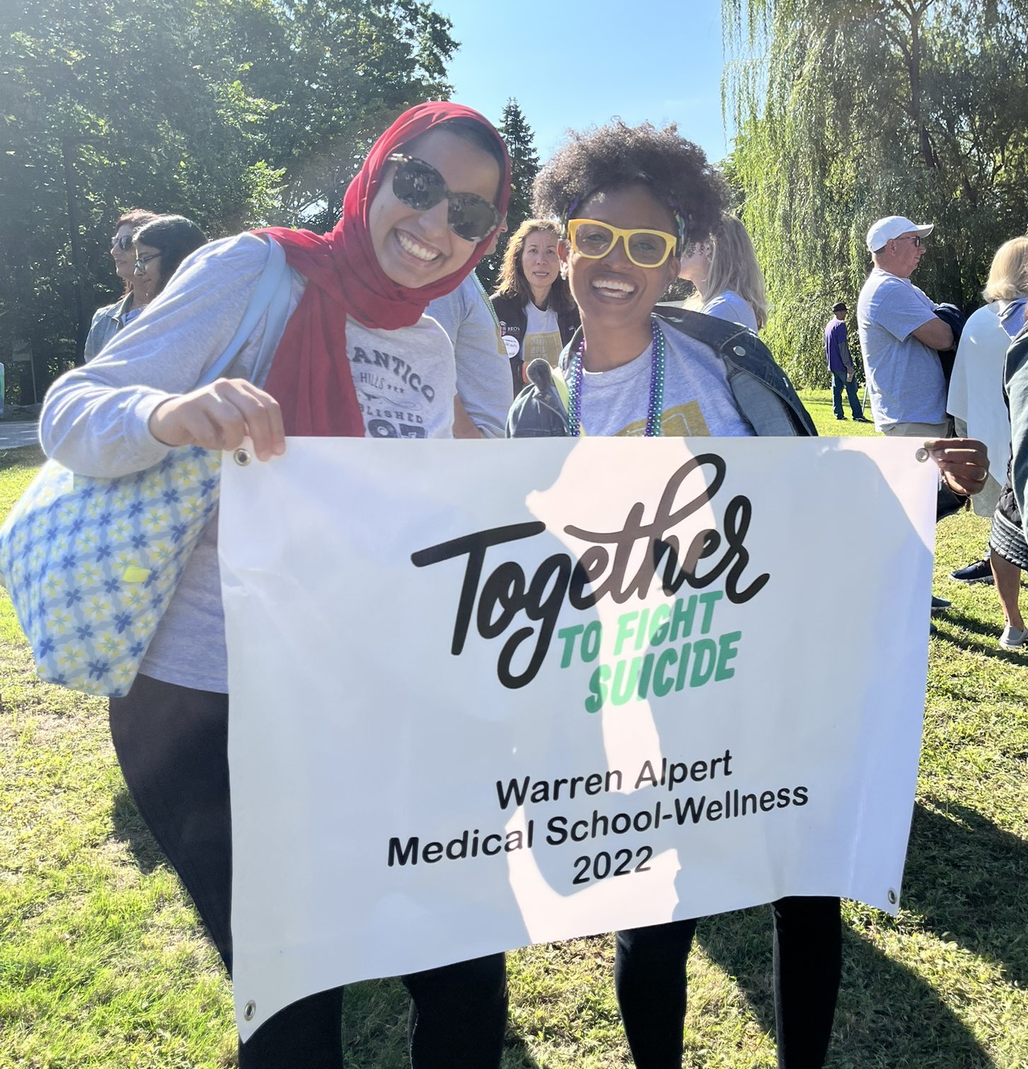 two people holding up banner about suicide prevention