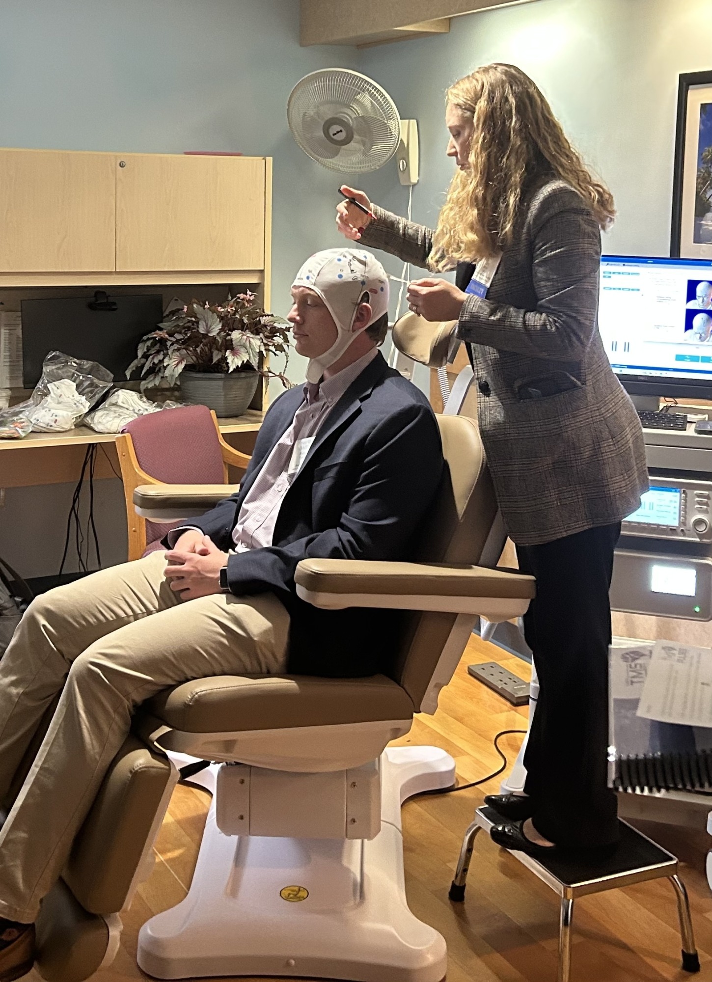 person standing over subject in a chair