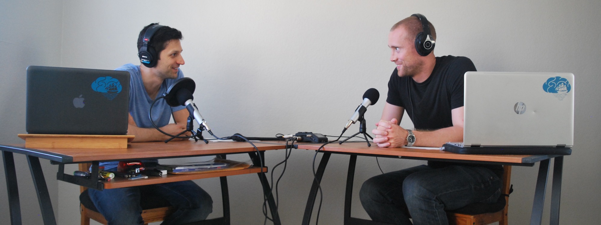 two people at laptops and microphones