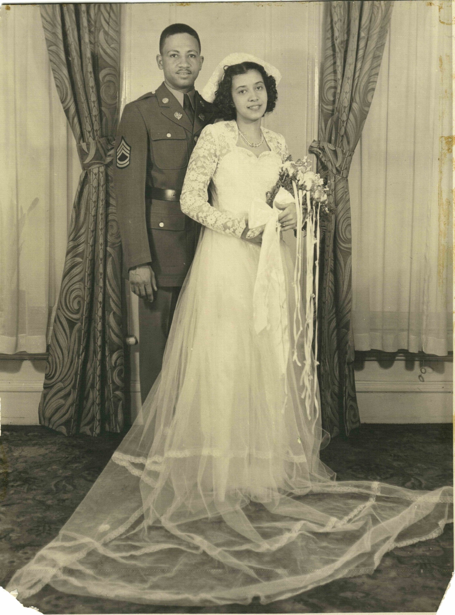 B&W photo of man in uniform and woman in wedding dress