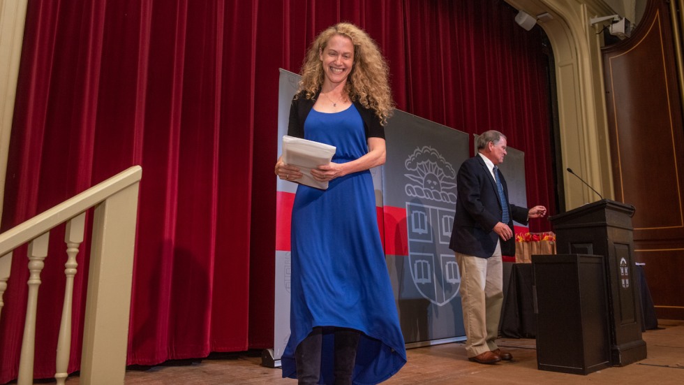 person with award on stage