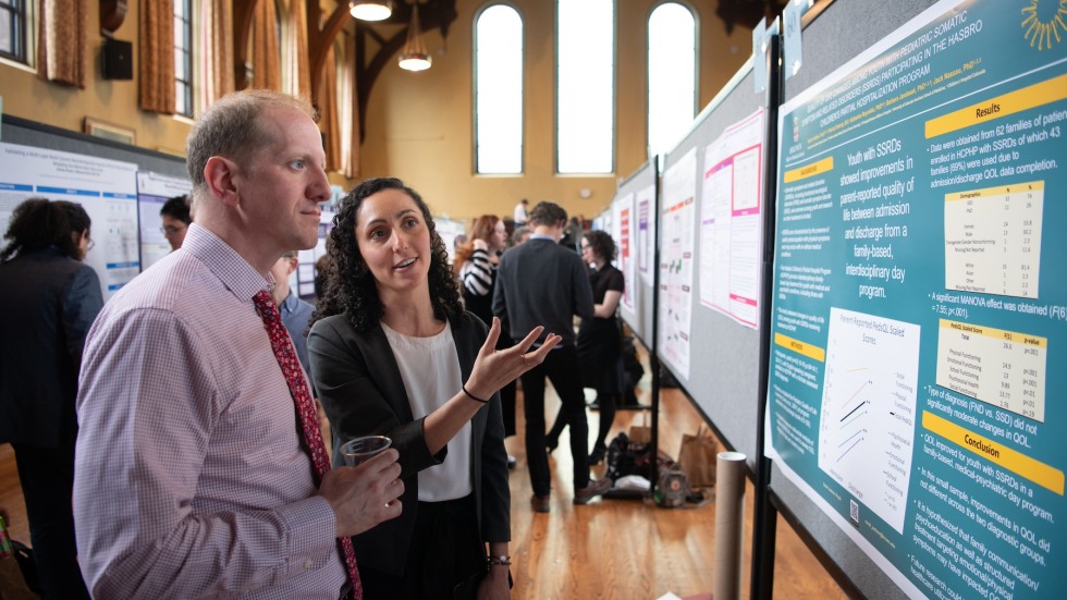 two people looking at poster