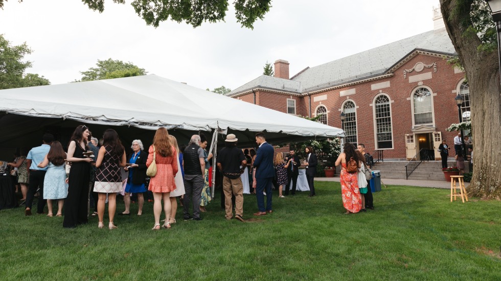 people standing under tent