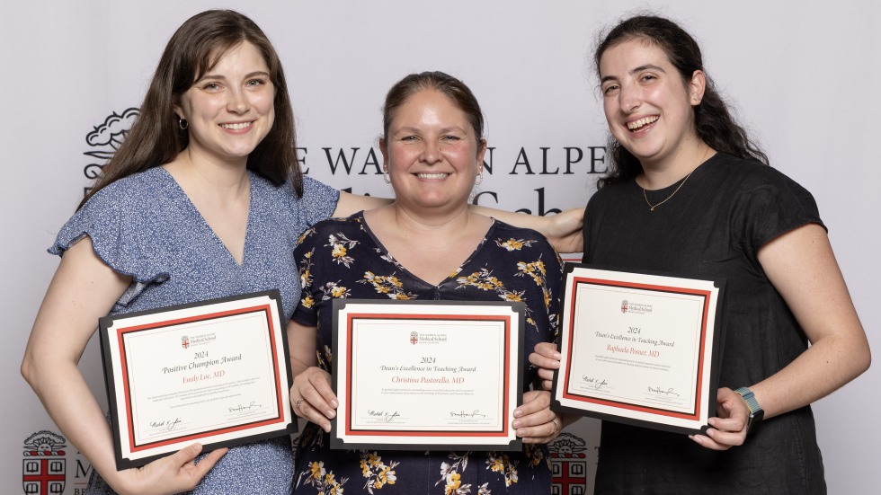 three people with awards
