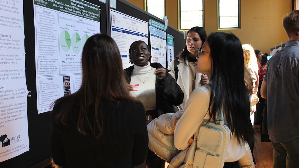 group listening to poster presenter