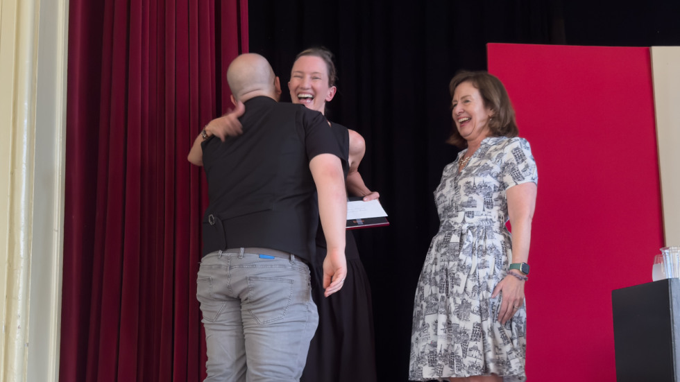 people hugging on stage
